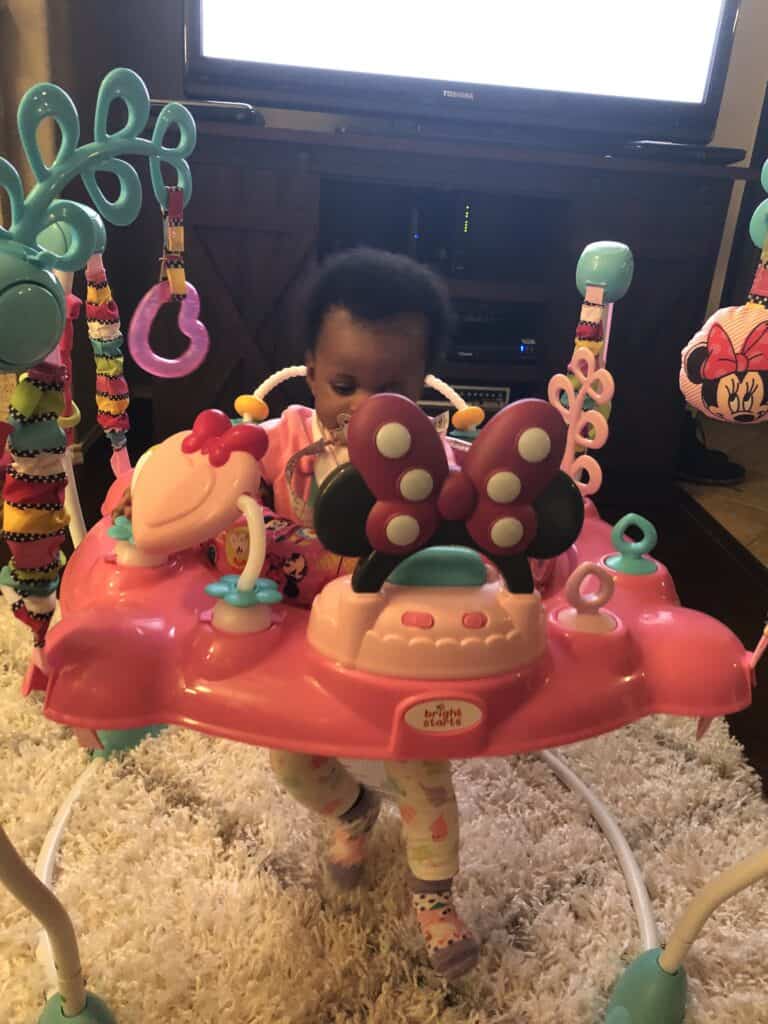 a picture of a baby in exersaucer showing when can baby use exersaucer